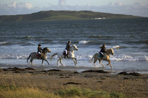 Children cantering ponies on Rush beach. Image courtesy of NiRiain Photography www.niriainphotography.com