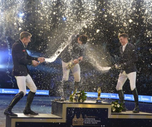 Michael Duffy (right) and William Whitaker (left) drench winner Billy Twomey with Champagne in a glittering prize giving following the Equestrian.com Liverpool Grand Prix